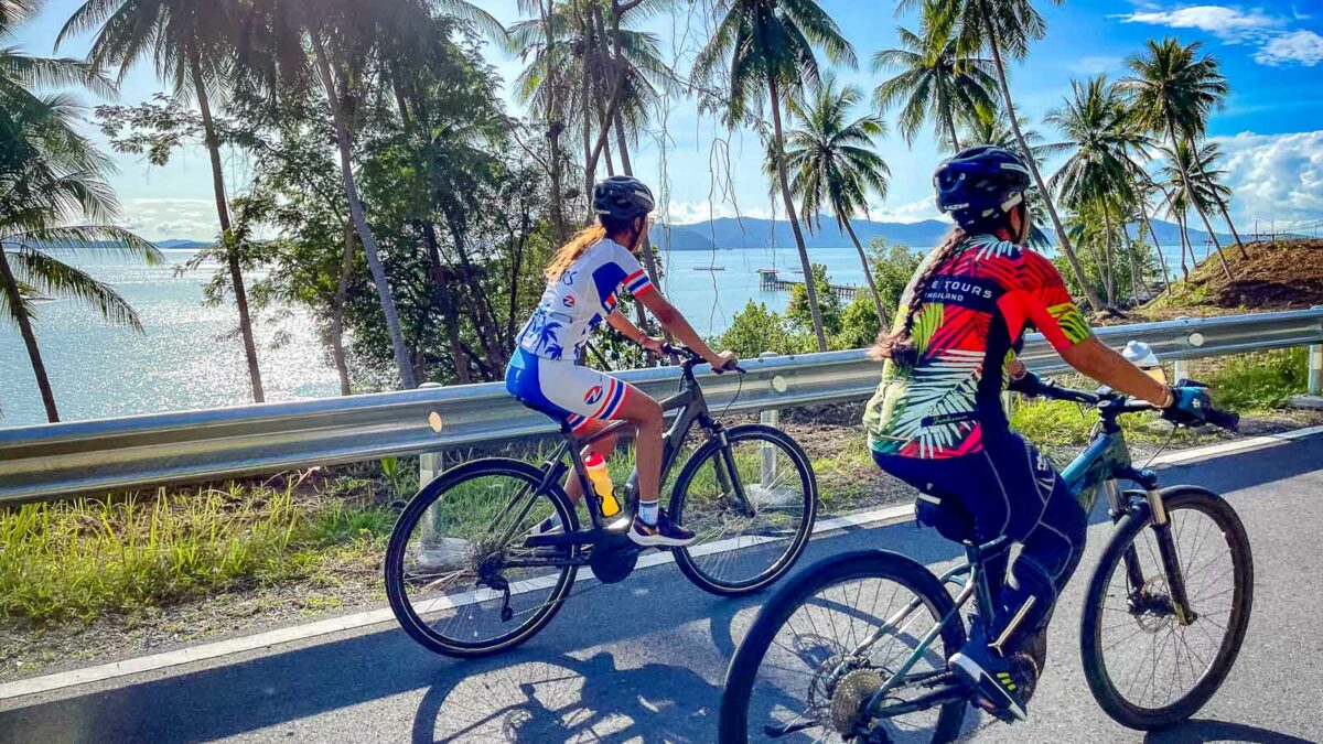 Cyclists riding along coast in Phuket, Thailand